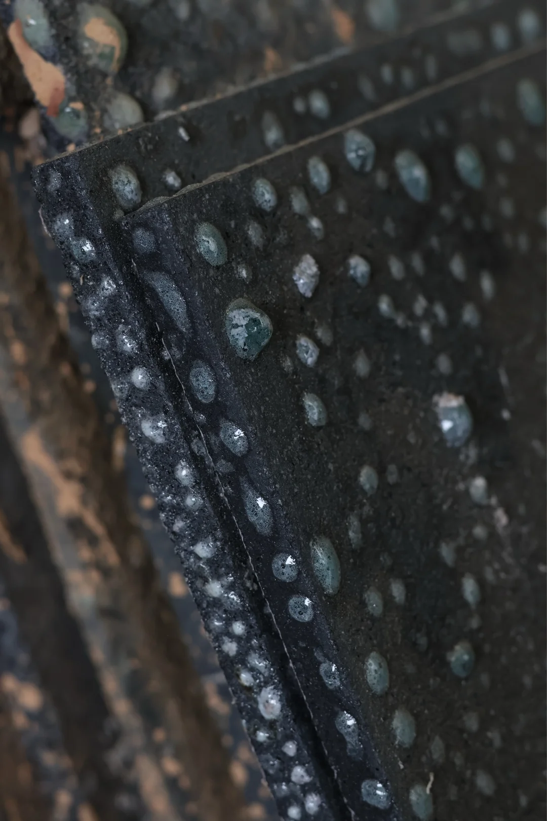 Close view of ceramic kiln shelves showing firing deposits