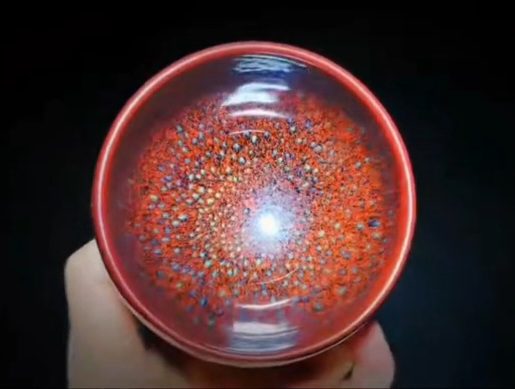Red crystalline Jian ware bowl by Lü Mengfei