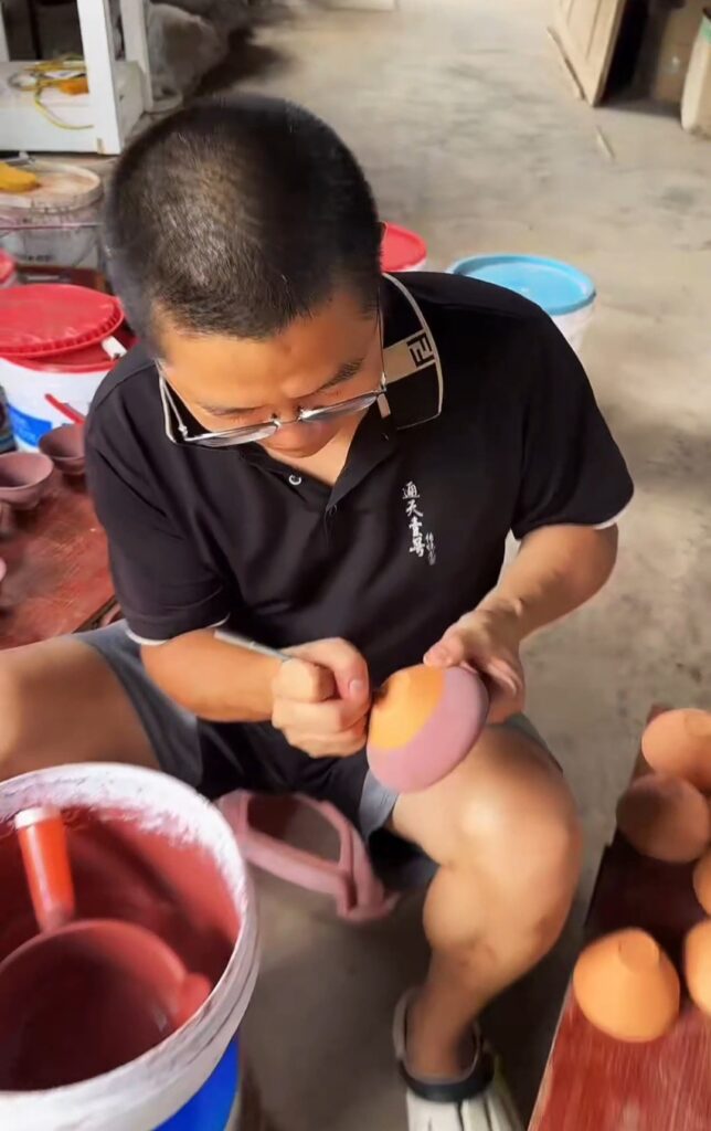 You Hui working with Jian Zhan in his studio