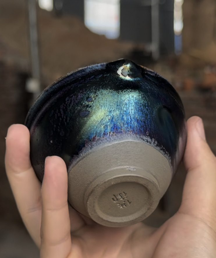 You Jiajun side-fired Jian ware showing base mark and directional glaze